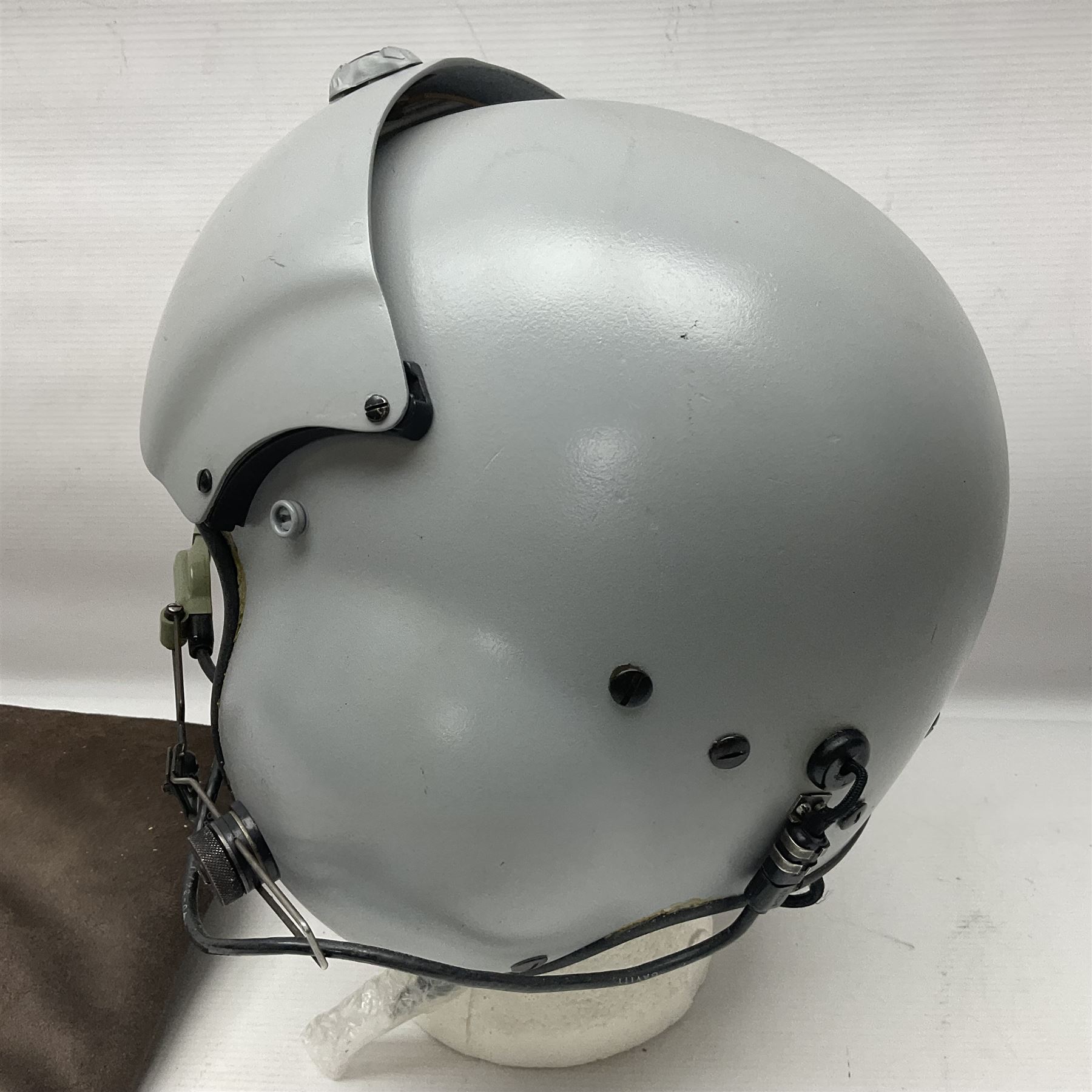Silver grey SPH-4B Flight Helmet as used by helicopter pilots in the USAF and US Army in the 1990s; made of epoxy resin reinforced fibreglass; fitted with clear and tinted visors and complete with an M-87A/AIC boom mike; original condition and bench tested.