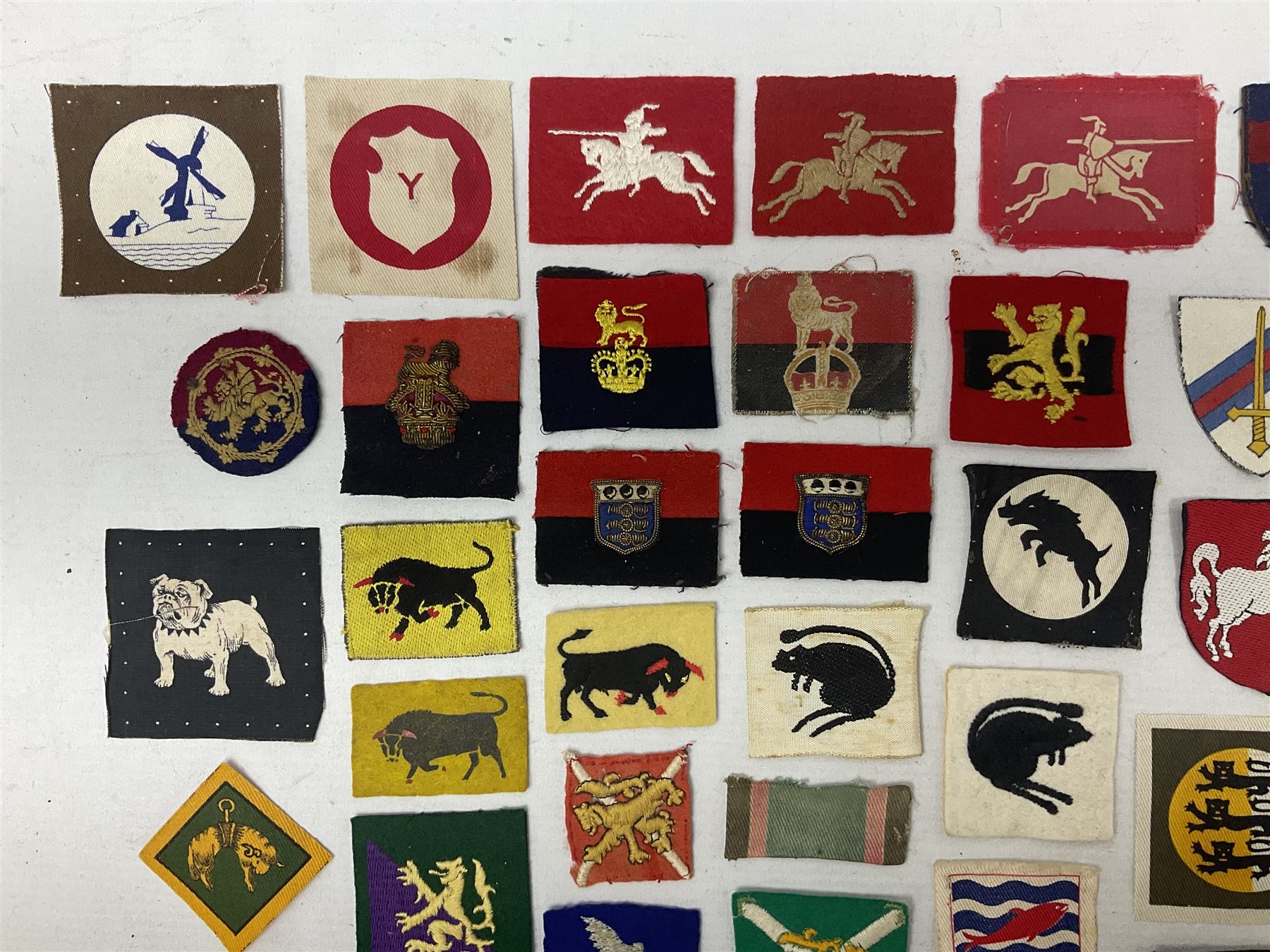 Approximately one-hundred printed and embroidered cloth badges including I, II, VIII, XI, XII and XXX Corps, Eastern Command, various Armoured Divisions, Midland, Wessex, Home Counties and 12th Infantry Brigades, Salisbury Plain, Northumberland, Hampshire, North Midland, West Riding, Essex and Suffolk Districts, Berlin & Rhine Army Troops etc