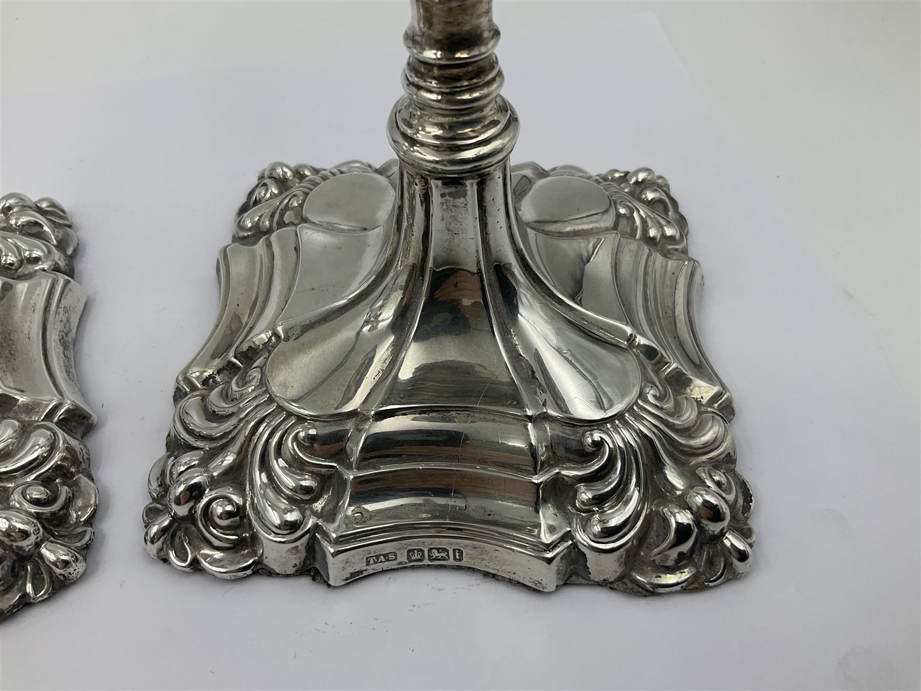 Pair of late Victorian silver mounted candlesticks, each of knopped and part fluted form, upon square stepped base with anthemions to each corner, with conforming sconces, hallmarked to removable sconces and foot, Thomas A Scott, Sheffield 1901, H25.2cm
