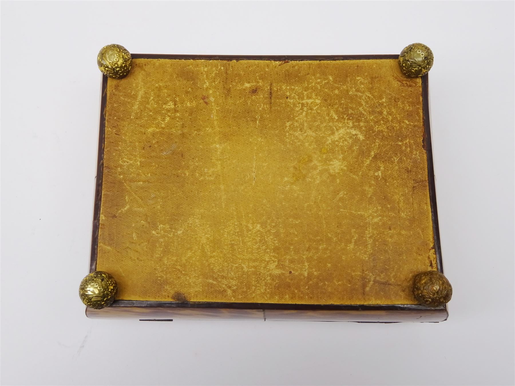 19th century tortoiseshell sewing box, of sarcophagal form upon four foliate detailed brass ball feet, the hinged cover edged in ivory with initialled silver plaque to centre, opening to reveal a silk lined interior, H9.5cm W22.5cm D18cm