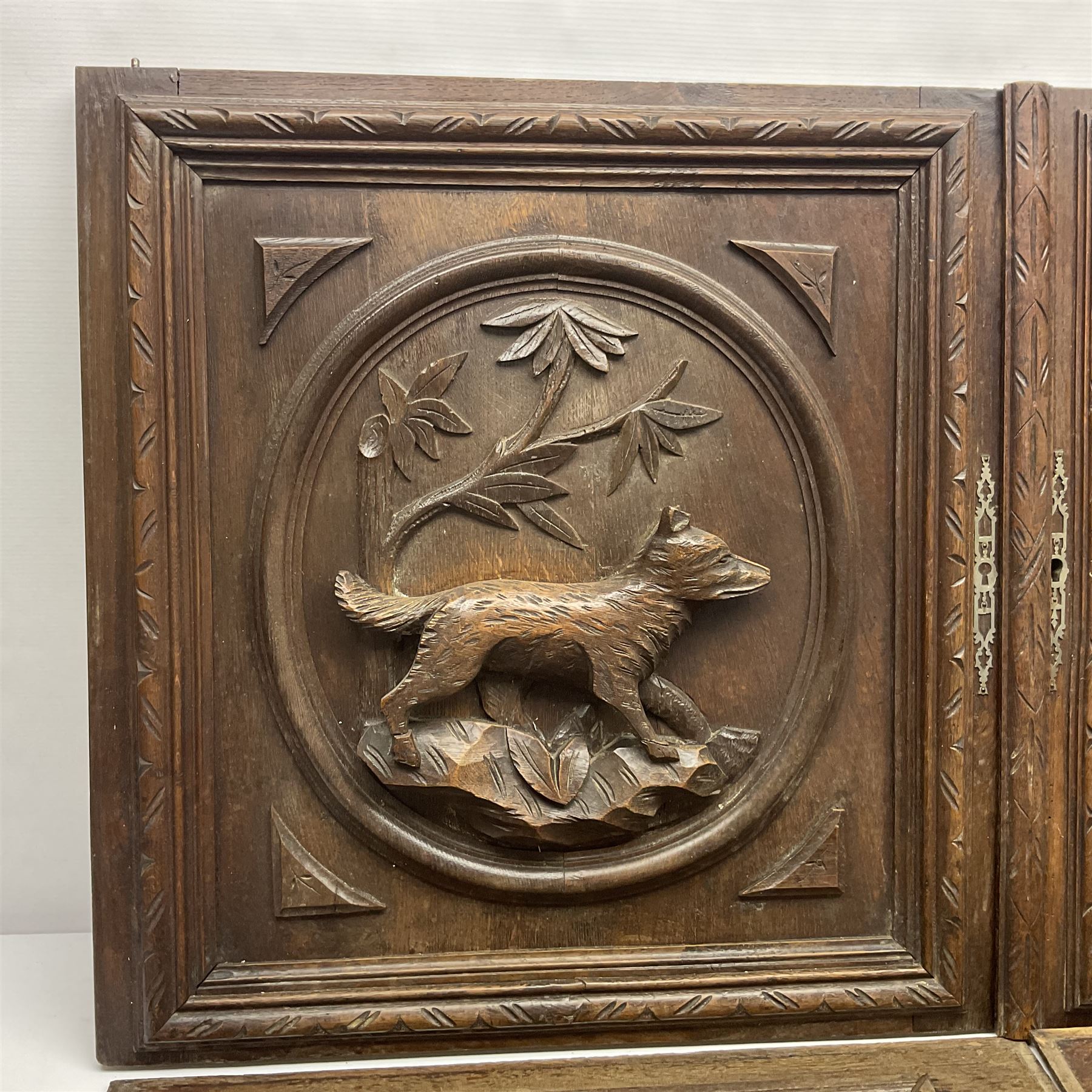 Pair of oak furniture door panels, carved in relief with a fox to one and a hound to the other, together with a pair of smaller oak panels, carved in relief with a hare to one and a grouse to the other, doors W63.cm x H62cm, panels W43cm x H60cm