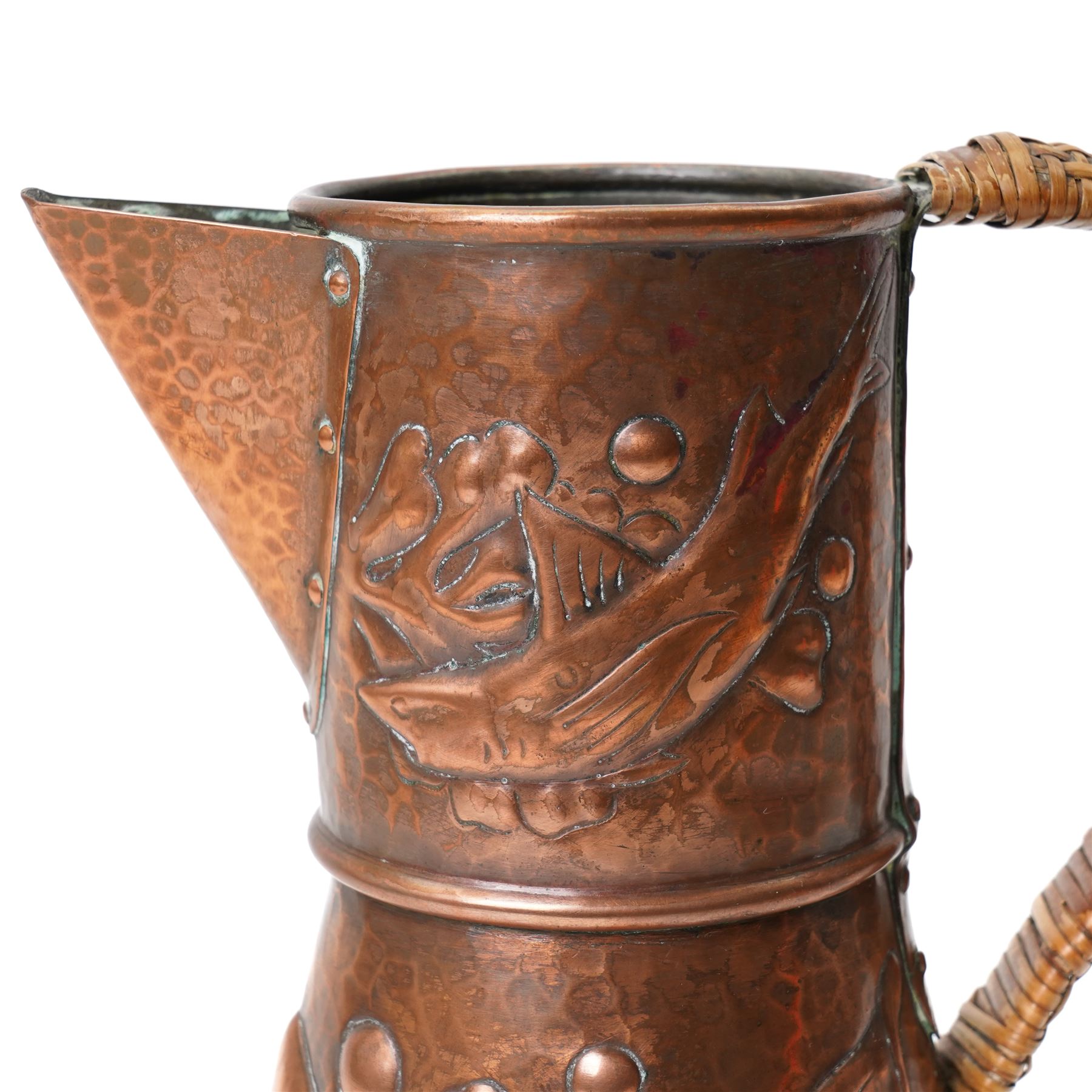 Newlyn Arts and Crafts beaten copper jug, the planished exterior decorated with fish, stamped Newlyn to base, H27cm 