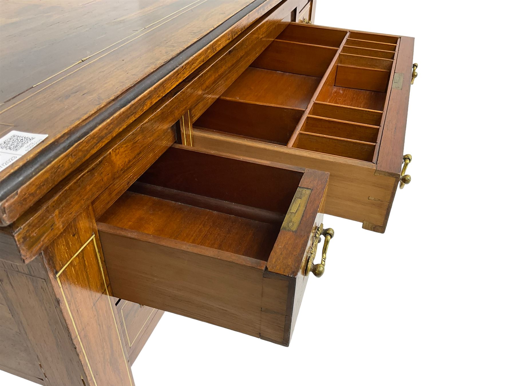 Edwardian inlaid mahogany games or work table, rectangular fold-over top inlaid with stylised dragon ivorine decoration and stringing, fitted with one long flanked by four small drawers over sewing compartment drawer, raised on square tapering supports with castors