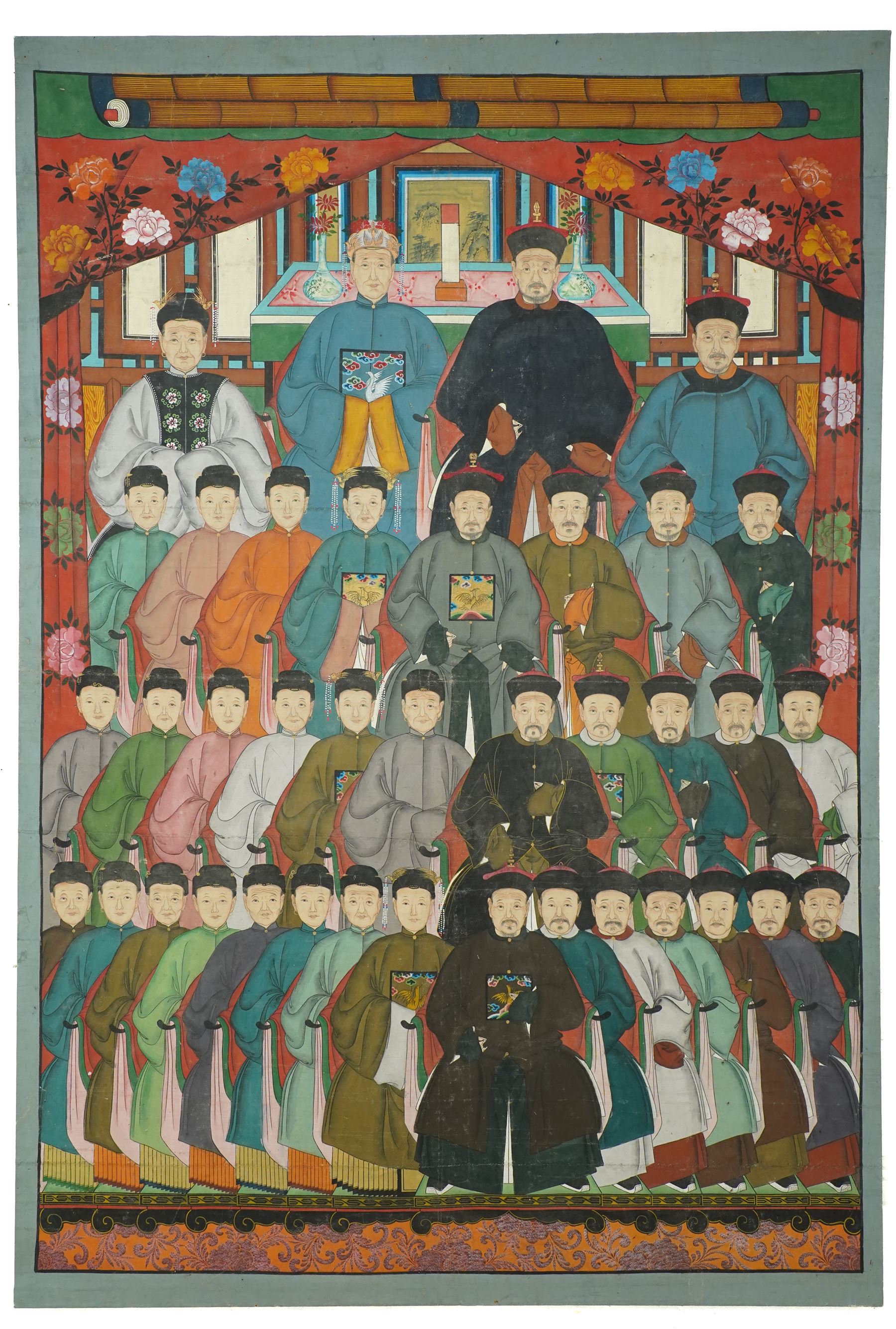 Large and impressive Chinese ancestral portrait, late Qing dynasty, gouache on stitched canvas with gilded highlights, showing thirty-eight sitters across four registers, the principal ancestors depicted before an altar table holding various ritual items, each in official dress and many wearing Golden Pheasant (Second-rank) and Silver Pheasant (Fifth-rank) Mandarin squares or 'buzi', overall 190cm x 131cm 