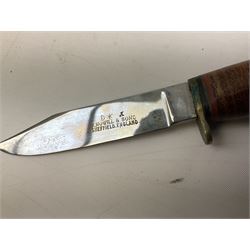 Graduated set of three Bowie knives by J. Nowill & Sons Sheffield England Est. AD1700, each with steel blade, brass cross-piece, stacked leather type grip and alloy pommel; largest blade 13cm and smallest 7.5cm; each in leather sheath (3)