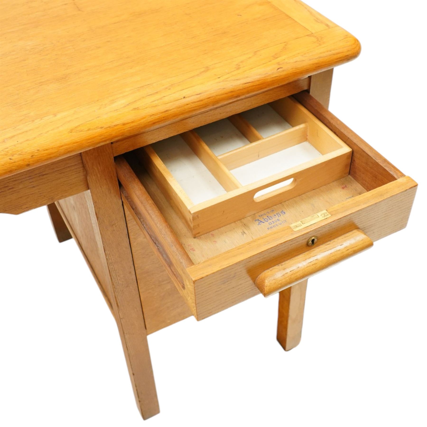 Abbess Woodwork Company - Mid  20th century solid oak single pedestal desk, rounded rectangular top with single pedestal, oak pull handles with fitted slide, above a drawer with cutlery divider, over a double height drawer, square tapering supports united by stretchers