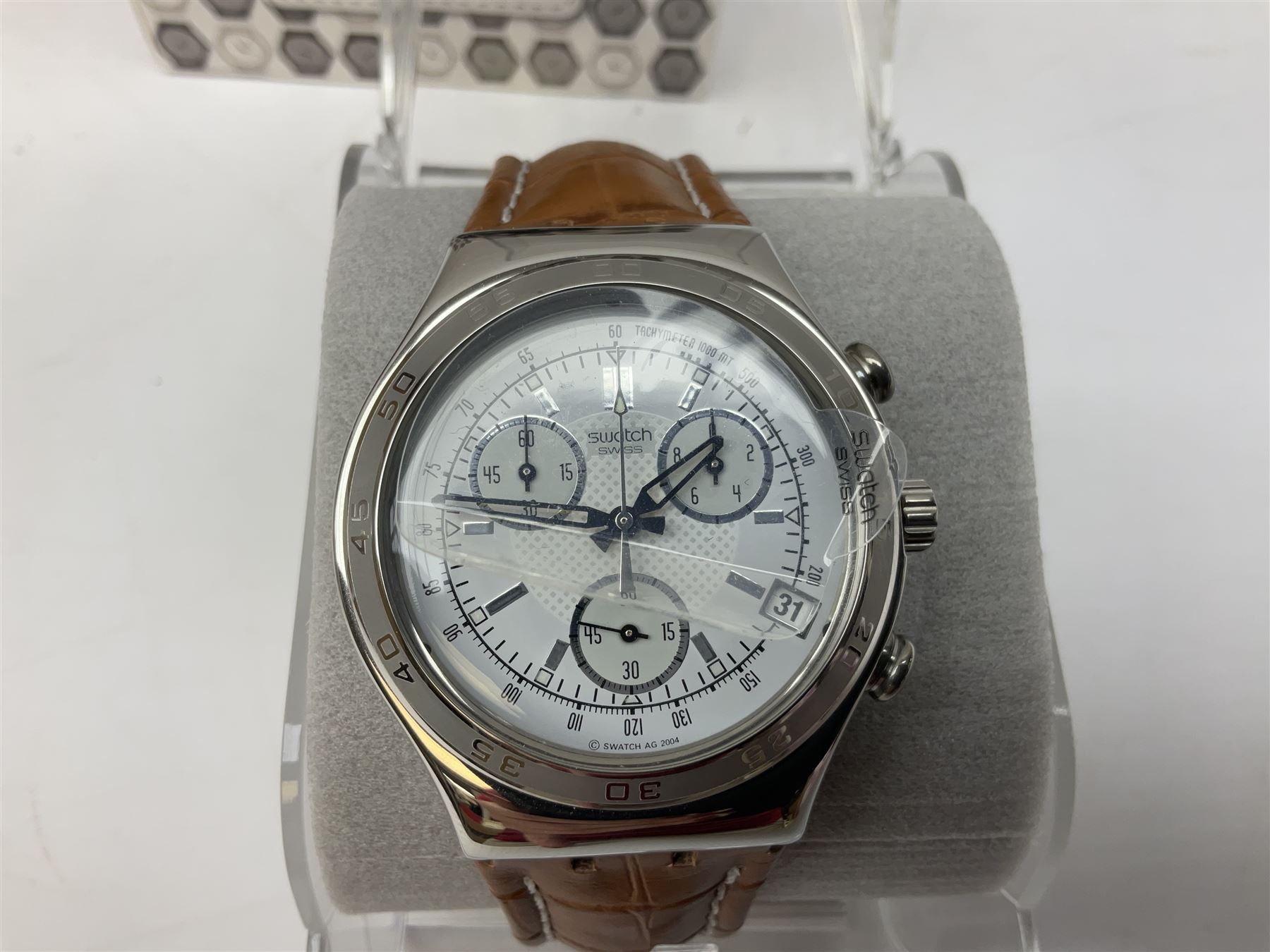 Swatch Irony chronograph stainless steel quartz wristwatch, on original tan leather strap and one other Irony quartz wristwatch, on stainless steel strap both boxed (2)