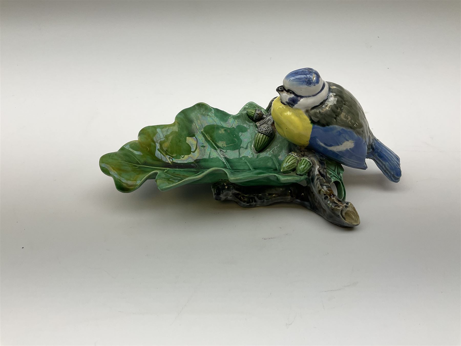 Minton majolica leaf dish, modelled as a Blue Tit perched on a branch with acorns and an oak leaf, date cypher for 1868, impressed marks beneath, L21cm. 