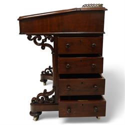 Large Victorian mahogany Davenport, the sloped leather inset writing surface opening to reveal fitted interior, with four drawers to one side and opposing dummy front cupboard door, carved scrolled supports and panelled back, raised on turned feet with brass castors 