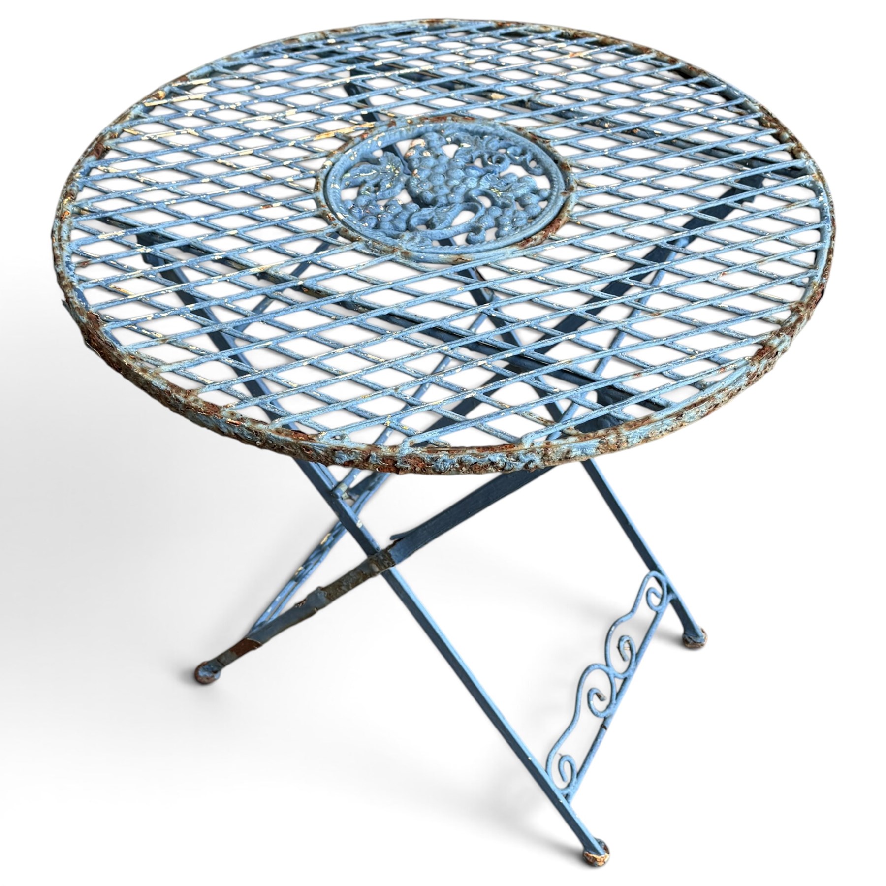 Three-piece French style blue-painted wrought iron garden bistro set, comprising a circular folding table with latticework top and central fruiting grapevine medallion (W71cm H76cm) and matching pair of chairs, with scrolling cresting rail and grapevine motif over folding X-frame base (W40cm H98cm)