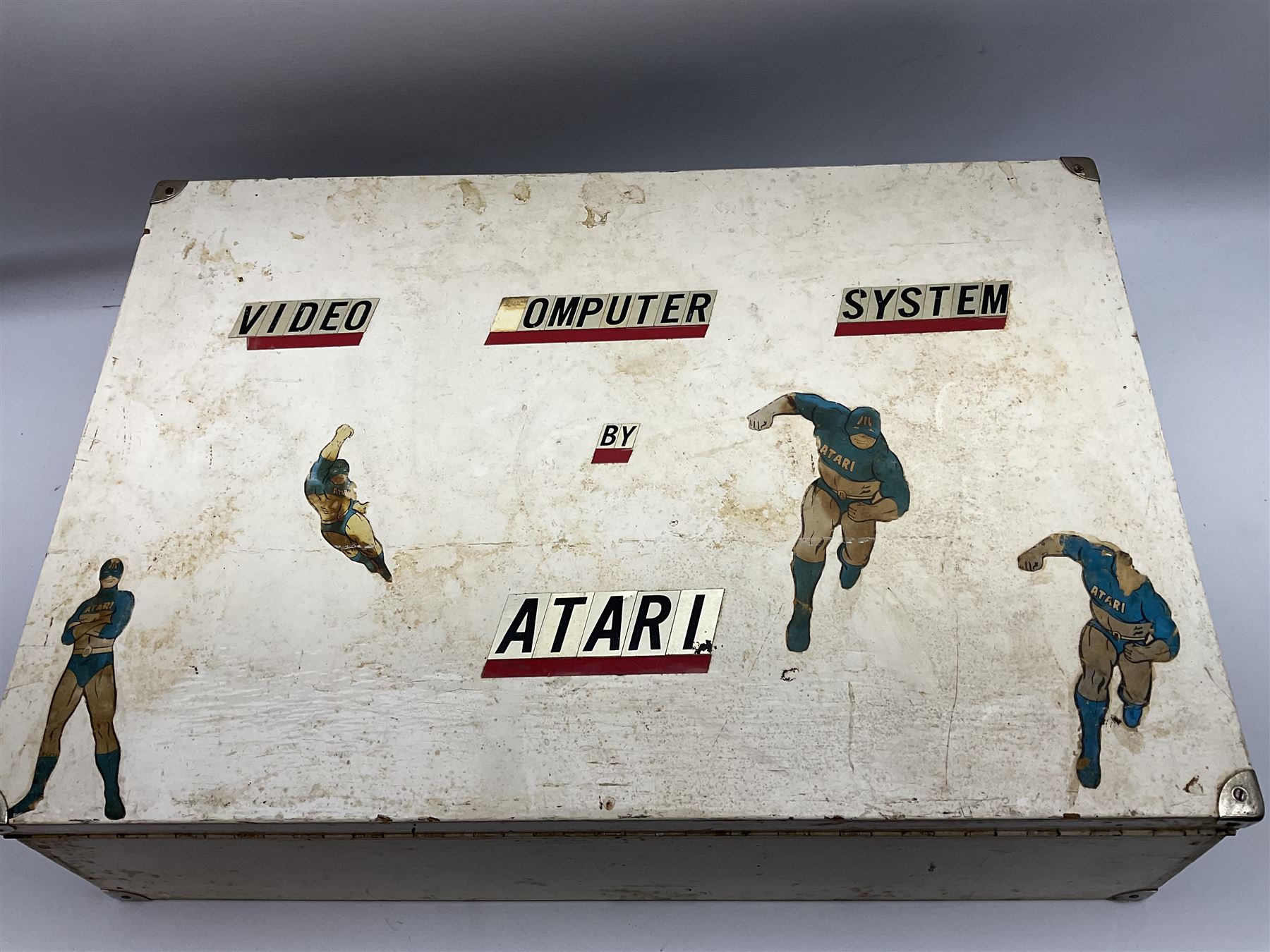 Atari 2600 'Woody' console with various joysticks and controllers etc, and a quantity of game cassettes to include 'Outlaw', 'Air Sea Seattle' and 'Codebreaker' etc housed in white painted wood case