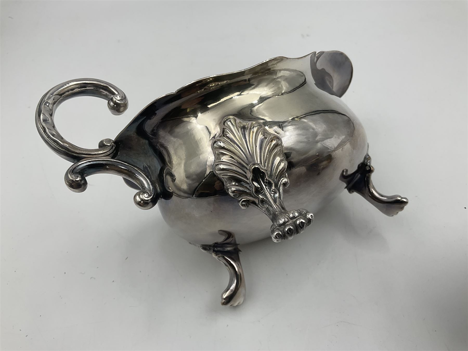 Silver plated seven bar toast rack by Mappin & Webb, together with other silver plated items including pair of bottle coasters, swing handled baskets and two sauce boats