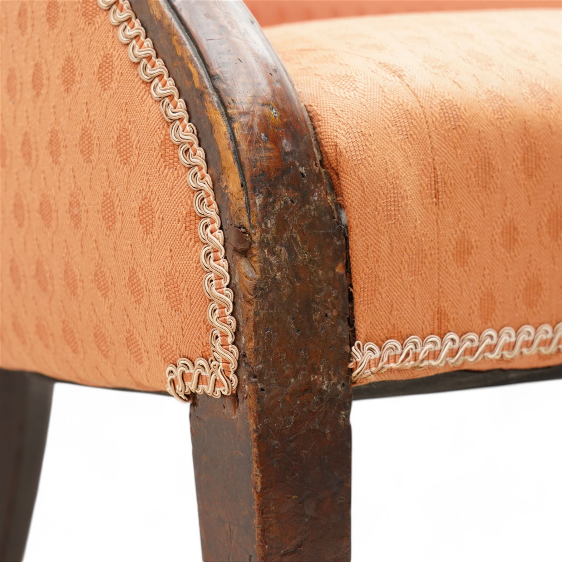 George III Hepplewhite design settee, arched back over serpentine set, upholstered in salmon fabric with repeating pattern, on square tapering supports with brass cups and castors 