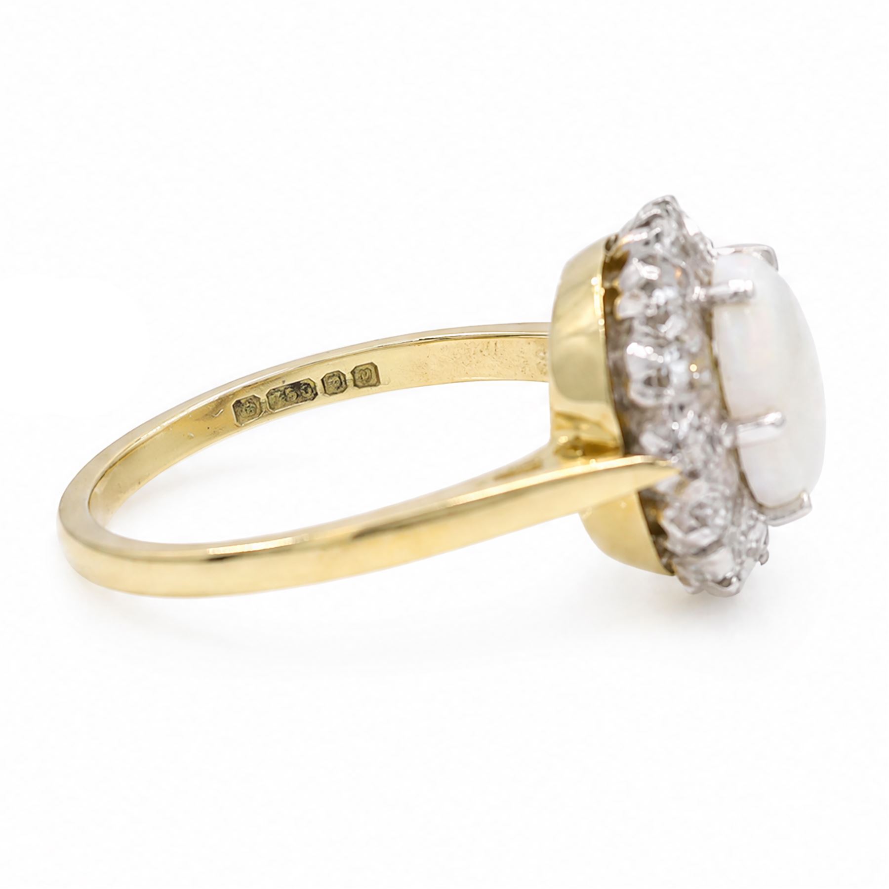 18ct gold opal and diamond cluster ring, oval cabochon cut opal surrounded by twelve single cut diamonds, London 1988