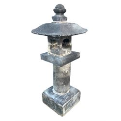 Japanese tea garden lantern in stone, pagoda top with finial on rectangular open lamp, cylinder column decorated with Japanese script, square plinth base