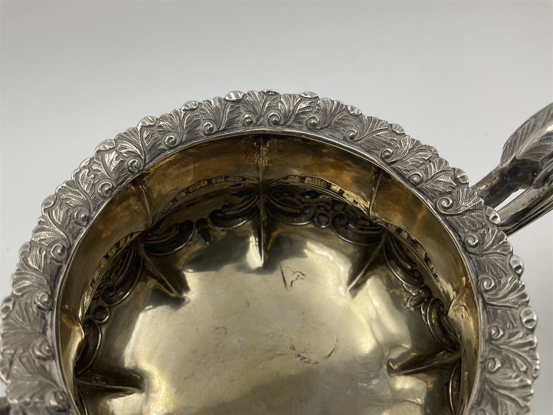 Victorian silver three piece tea service, comprising teapot, twin handled open sucrier, and milk jug, each of bellied form with acanthus capped scroll handles, the sides embossed with alternating scroll edged vacant panels and panels containing a pair of birds, upon four palmette feet, the teapot with ivory insulators to handle, and bird finial to the hinged domed cover, hallmarked William Hunter & Son, London 1861, teapot H19cm, including handles sucrier H13.5cm, including handle milk jug H12cm

This item has been registered for sale under Section 10 of the APHA Ivory Act