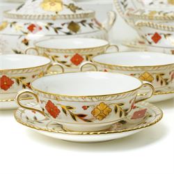 Royal Crown Derby Asian Rose pattern dinner service for twelve covers comprising  twelve dinner plates, twelve dessert plates, twelve two handled soup bowls and stands, pair of sauce boats and stands, pair of sauce tureens with covers and stands, pair of vegetable dishes and covers and two graduated meat plates, date code 1974