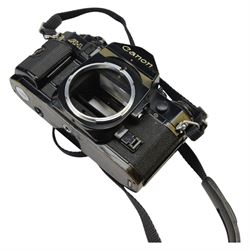 Two Canon SLR camera bodies, comprising Canon A-1 serial no. 718442 and Canon T90 serial no. 1195139, together with a Canon FD 50mm 1:1.8 lens, Canon FD 100-300mm 1:5.6 zoom lens, Vivitar 200mm 1:3.5 Auto Telephoto lens no. 28403440, Vivitar 24mm 1:2.8 Auto Wide Angle Lens and Sigma Telephoto 1:5.6 f=400mm lens and other accessories contained within two soft carry cases