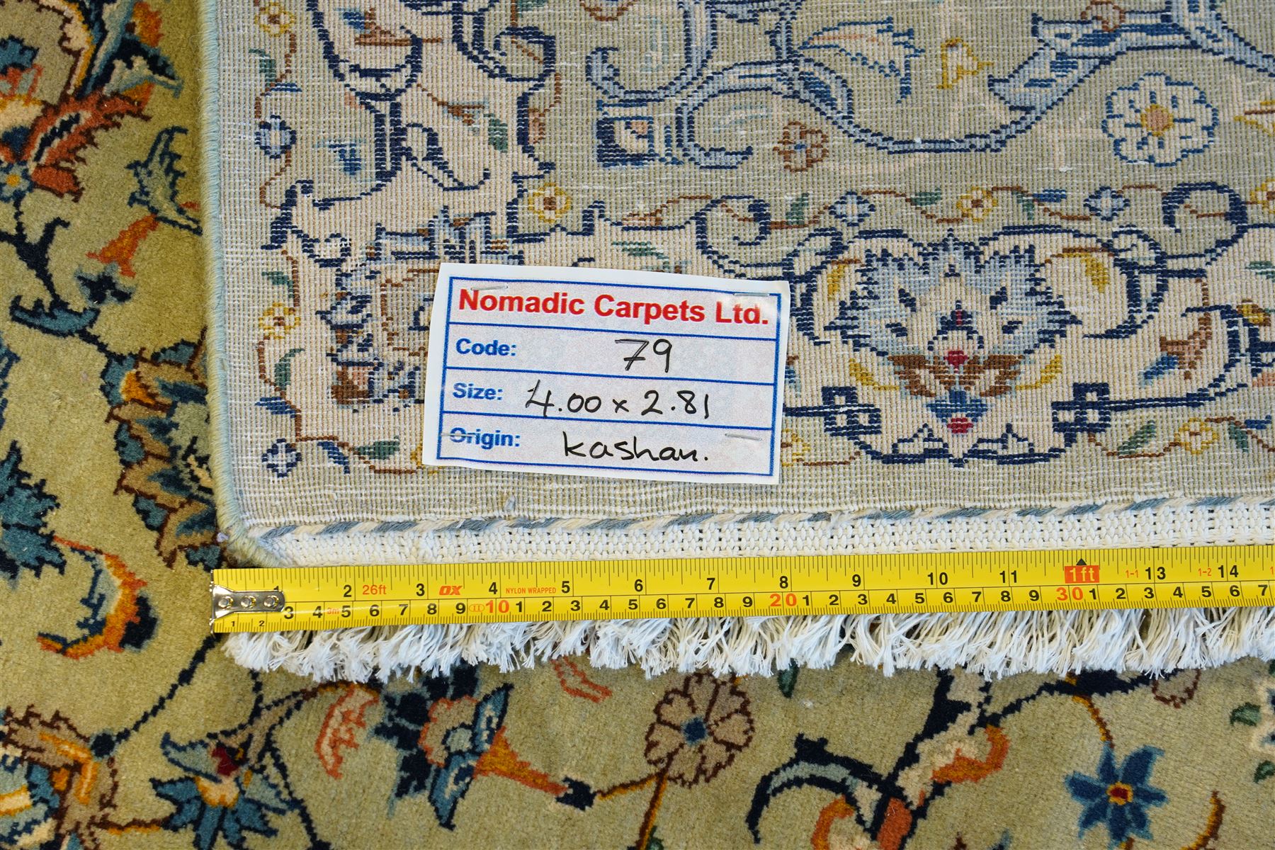 Central Persian Kashan hand-knotted carpet, pale blue field decorated with a finely drawn all-over scrolling floral vine design incorporating stylized palmettes, rosettes and foliate sprays, with a small central circular medallion, enclosed by a conforming floral vine border between multiple guard stripes, with cotton fringe ends  