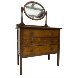 Early 20th century oak dressing chest, raised back with oval swing mirror and bevelled plate, fitted with three drawers