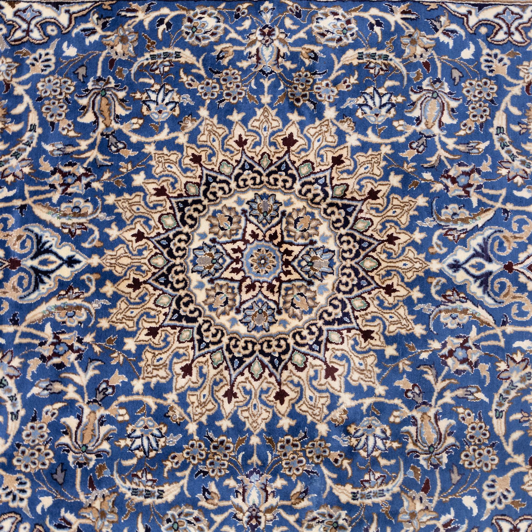 Central Persian Nain hand-knotted rug, soft blue field with central medallion with finely drawn scrolling palmettes and floral tendrils, with ivory spandrels, enclosed by a floral meander border flanked by multiple guard stripes with cotton fringe ends 