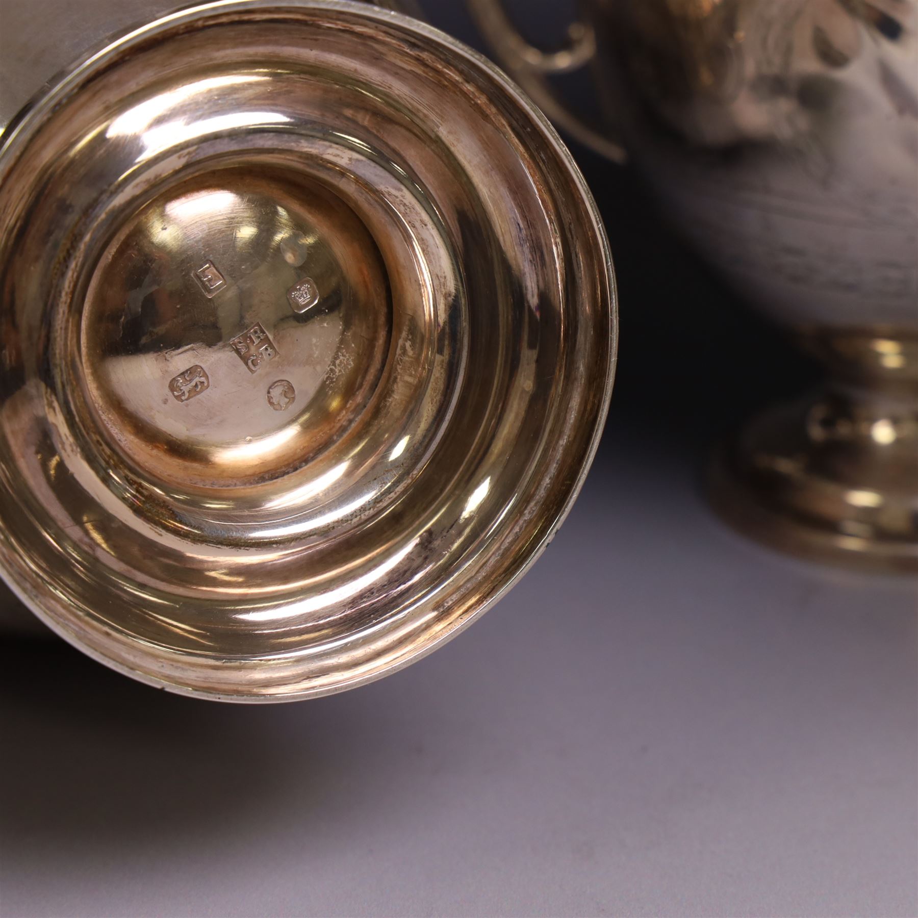 Early 20th century four piece silver tea service, comprising teapot, hot water pot, open sucrier and milk jug, all of oval bellied form with oblique gadrooned rim and upon four feet, the hotwater and teapot with wooden handles and finials, hallmarked William Lister & Sons, Sheffield 1912