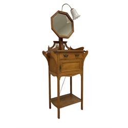 Late 19th to early 20th century oak washstand, the raised back with octagonal mirror with bevelled plate, rectangular top fitted with single drawer and cupboard with handles to each side, over under-tier, raised on square supports, with later light fitting