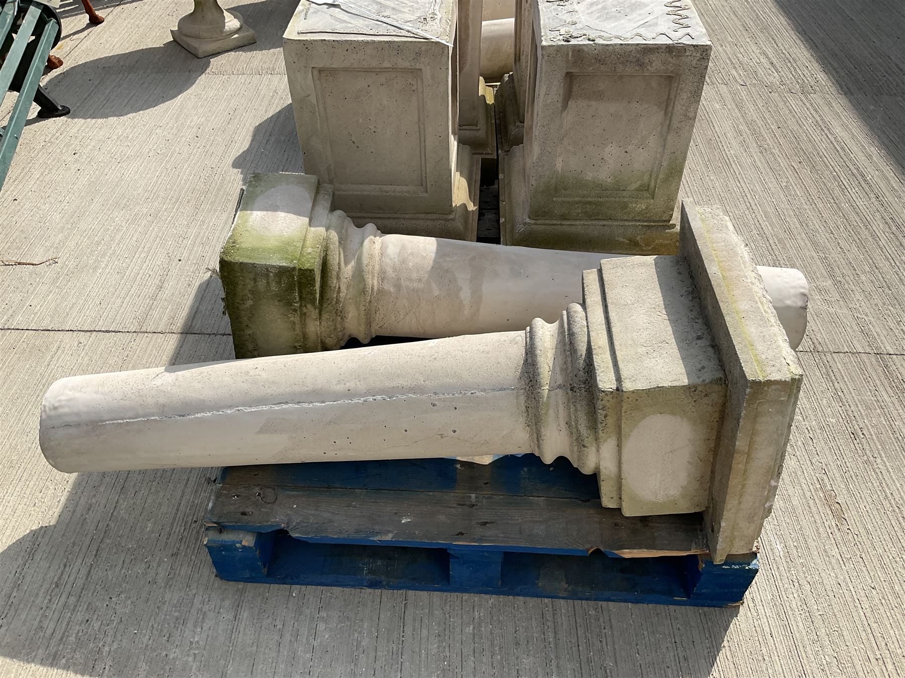 Set of four cast stone architectural columns, tapering form, on square plinth bases