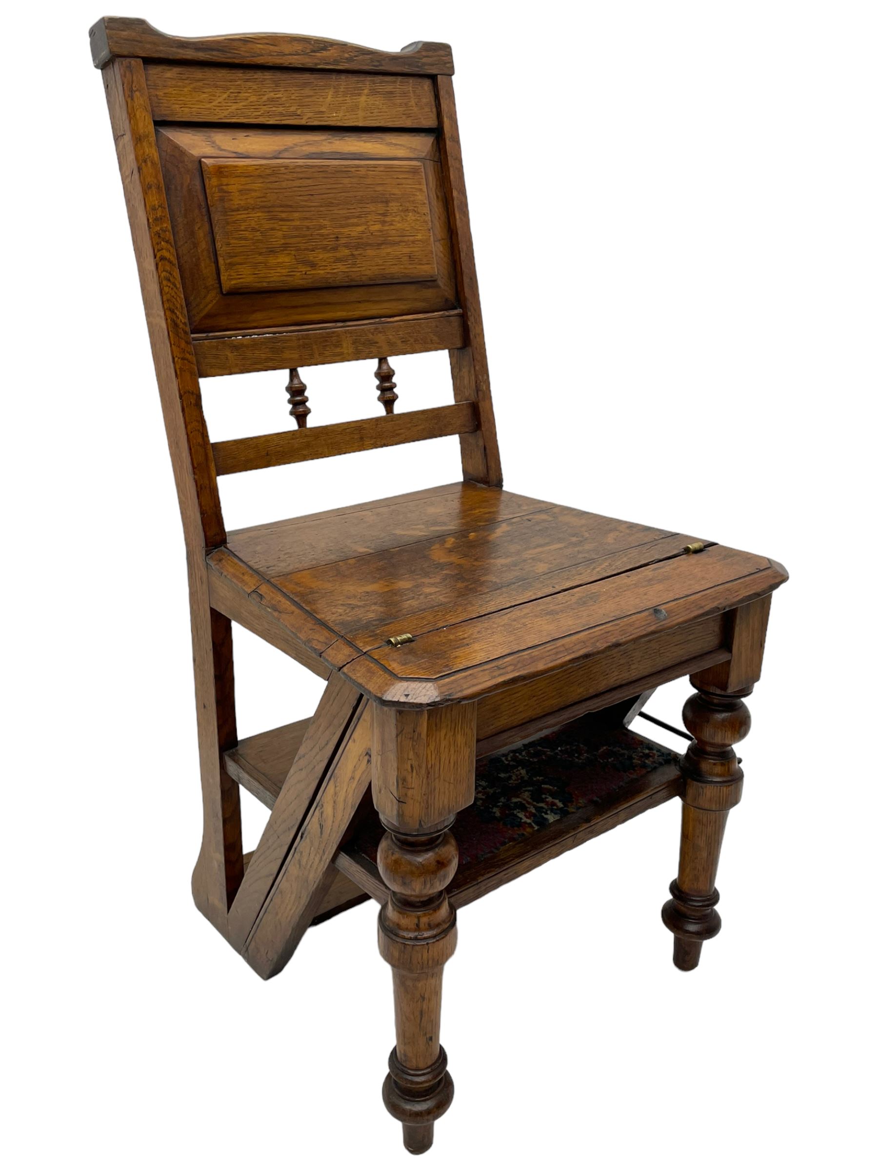 19th century oak metamorphic library steps and chair, panelled back with turned spindles over plank seat with turned front supports, the hinged seat folding forward, the steps inset with carpet treads  