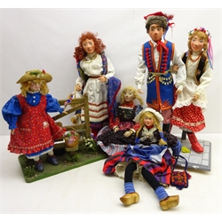  Five hand crafted composite dolls designed by Margaret Hickson Dutch couple mounted on stand, H71cm, another depicting a young girl stood by stile and dog and three others (5)  