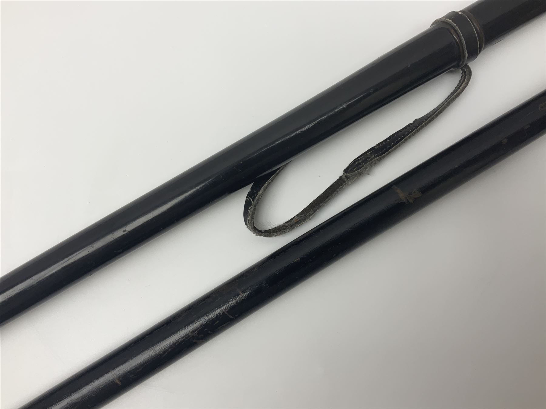 Two ebonised walking sticks, one with 'Leeds City Police' embossed top, tallest H92cm