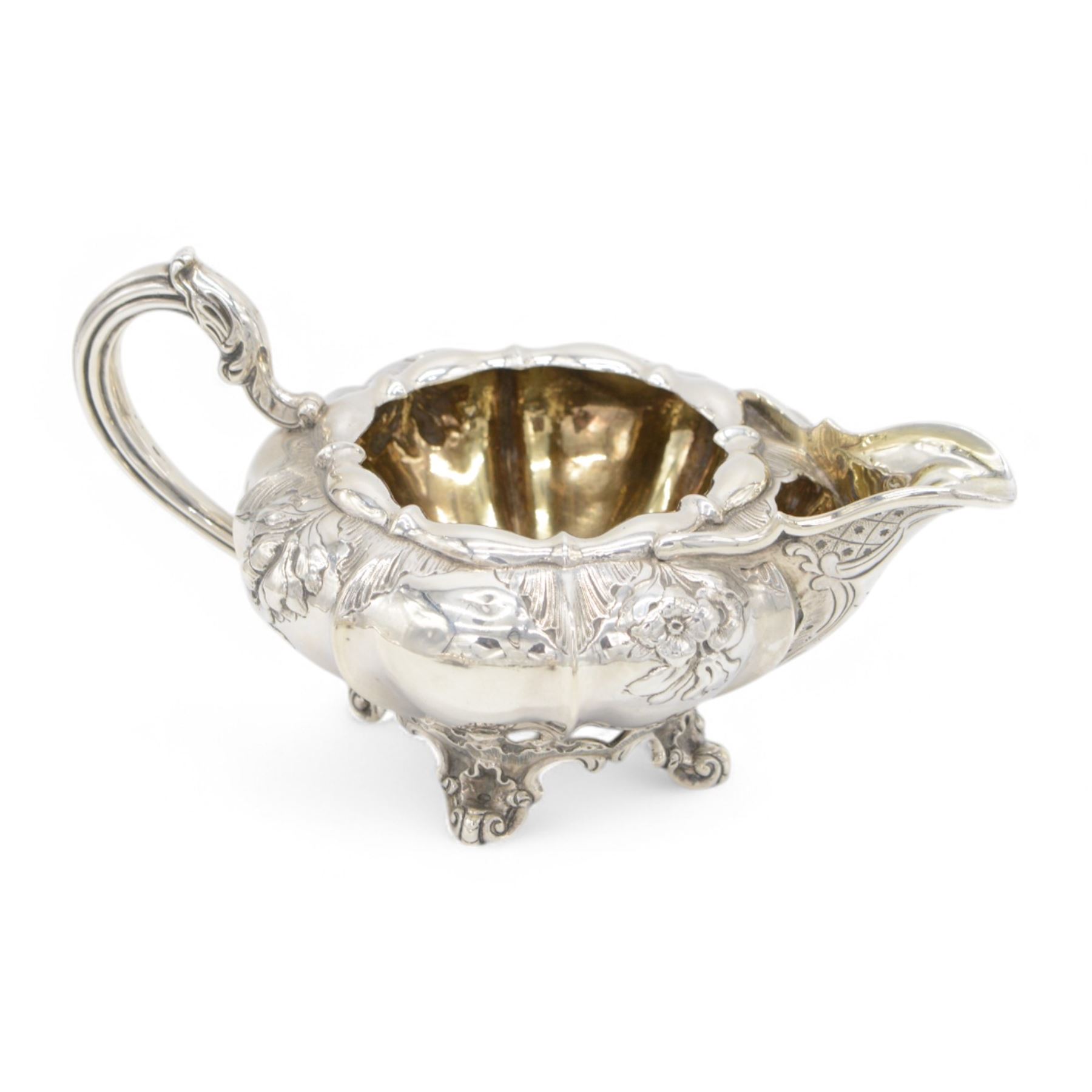 William IV silver twin handled sucrier and milk jug, each of circular bellied form, embossed with floral decoration, upon four pad scroll feet, hallmarked London 1831, maker's marks CE, including handles H10cm