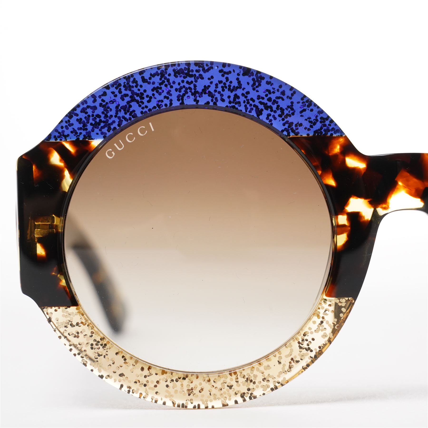 Gucci - pair of oversized round sunglasses, with gradient tinted lenses in a tortoiseshell-effect frame with blue and gold glitter inlay, the temples with interlocking gold-tone GG logo and bee motif, unused with original cloth and hard cases