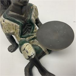 Bronze figure of a seated man resting on a sack
