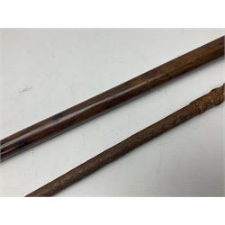19th century wooden walking stick, the handle carved as a snake within a clenched fist, the cane carved with foliate and cross hatched decoration, with a metal spike to base, together with a turned wooden walking stick, with lacquered rope nautical knot handle, tallest L96.5cm