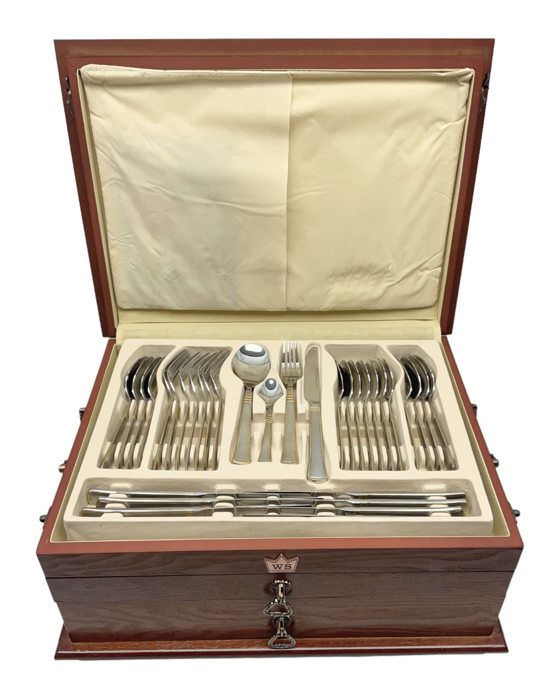 Waltmann und Sohn part canteen of stainless steel and gilt cutlery, the stained wood case with hinged lid above two fitted drawers, L48cm