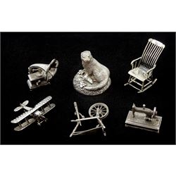 Collection of silver miniatures including a WWI fighter aeroplane the underside of the body engraved 'Bristol' by Italian Medusa Oro 925, gramophone, spinning wheel by S M C, London import marks 1982, sewing machine and chair, all stamped 925 or hallmarked and a silver filled otter by Country Artists