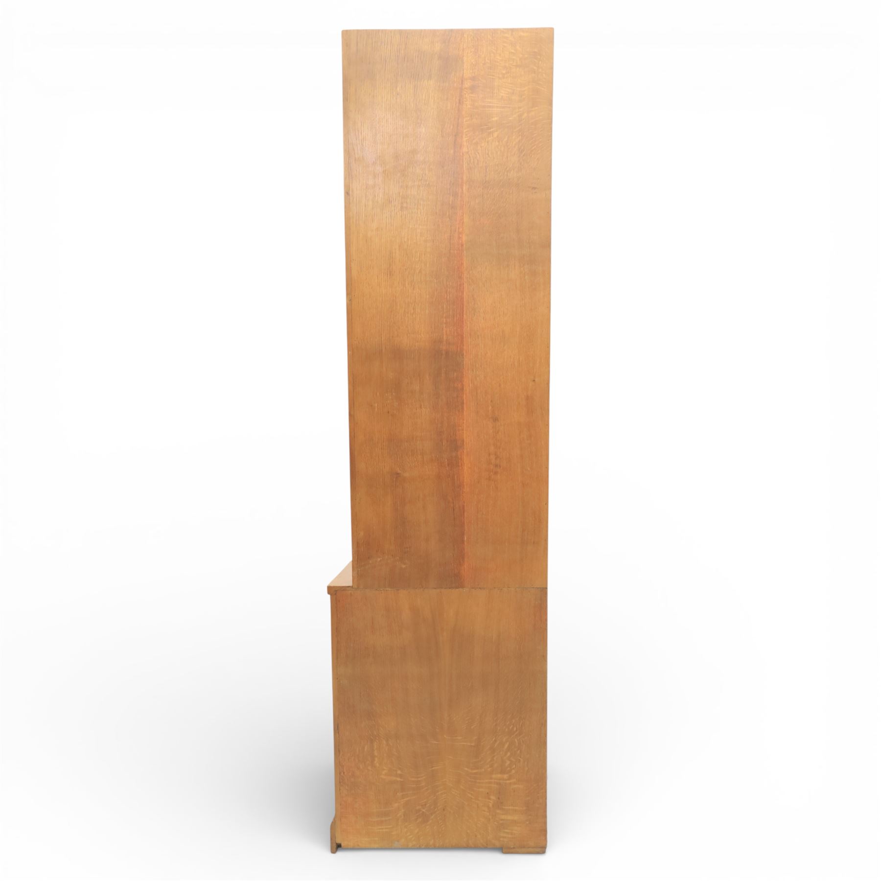 Cat & Mouseman - oak corner cabinet, glazed door with two fixed glass shelves, above a panelled door and sides raised on a plinth base, with cat and mouse carving to the lower side by Lyndon Hammell a former apprentice of Robert 'Mouseman' Thompson