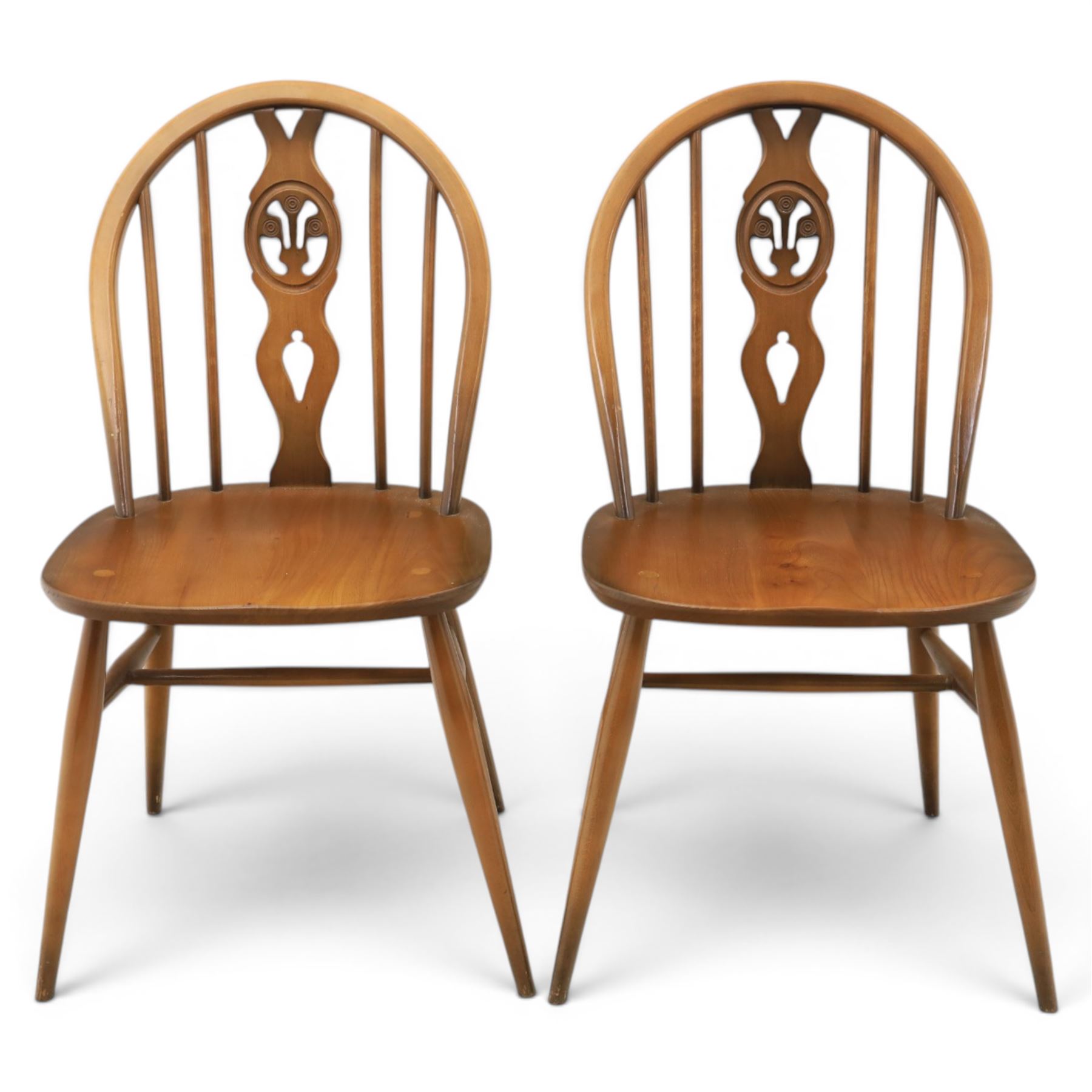 Ercol - Set of four dark elm 'Fleur De Lys' chairs