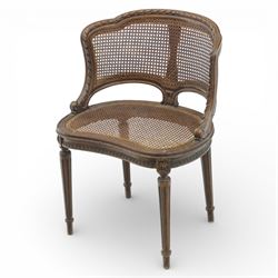 Late 19th century cane bergère armchair, the serpentine shaped back flowing into enclosed arms, the back and seat caned throughout, with carved detail to the crest and arm terminals, on turned legs