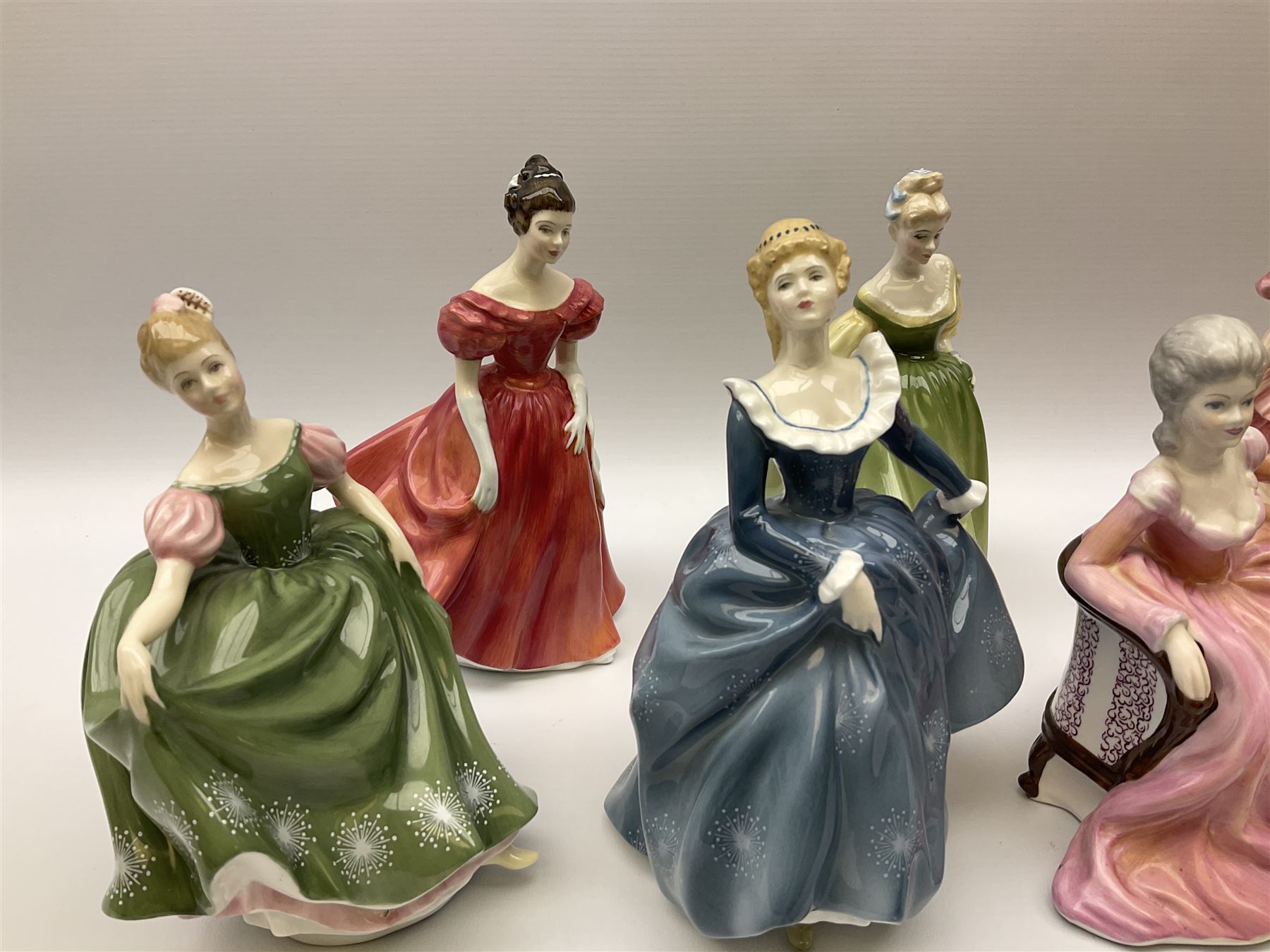 A group of eight Royal Doulton figures, comprising Simone HN2378, Amy HN3854, Fragrance HN2334, Louise HN3207, Adrienne H2304, Michele HN2234, Fine Lady HN2193, Winsome HN2220 and a Coalport figure, Polly. 