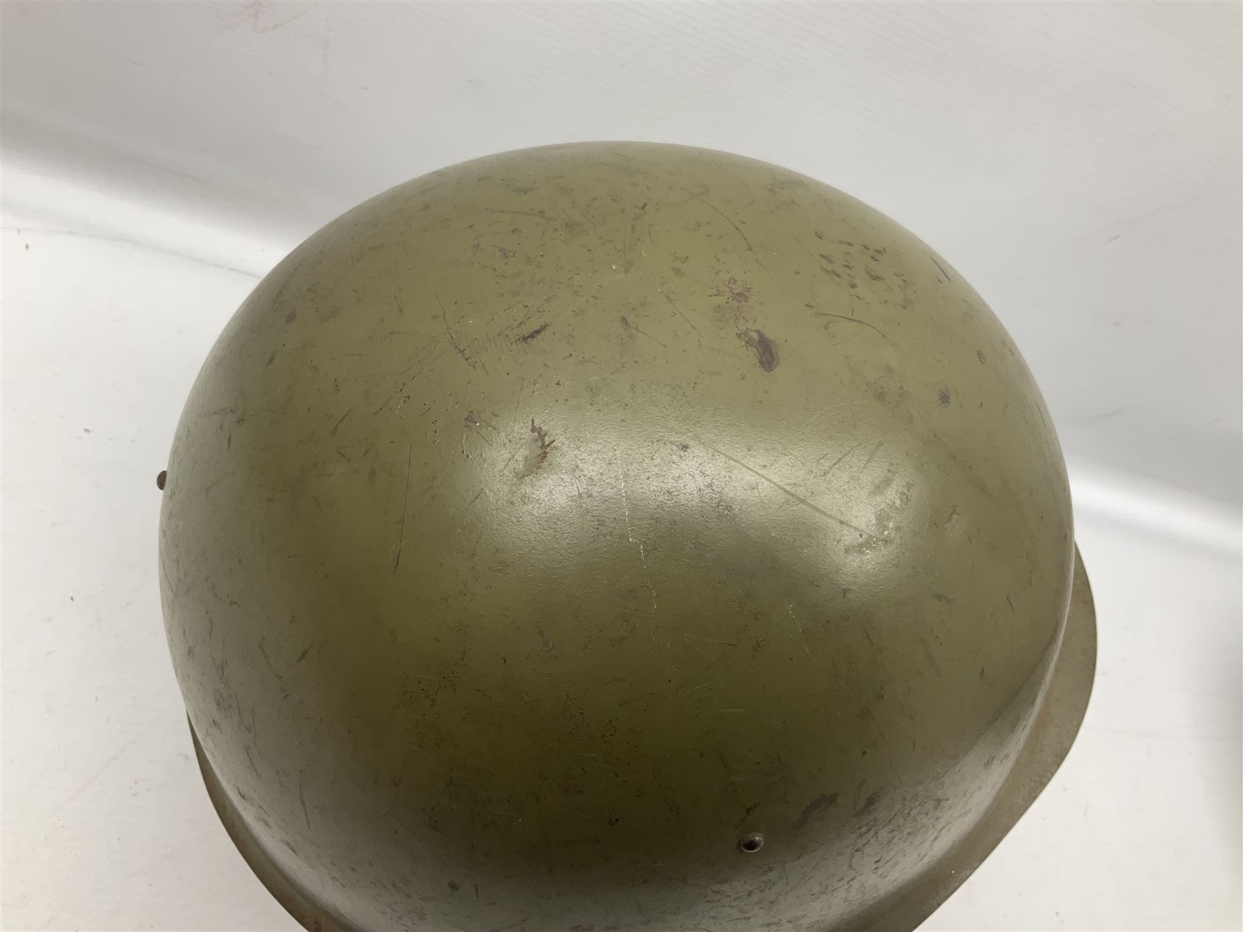 Two 1960s East Block Soviet style helmets - Czechoslovakian and Russian; both with liners (2)