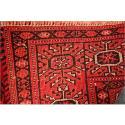  Bokhara red ground rug, repeating elephant foot medallions, 240cm x 188cm  