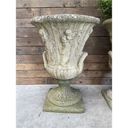 Set of four Victorian design cast stone Grecian urns, tapering form cast with figures and handles, square plinth bases