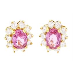 Pair of 18ct gold pink sapphire and diamond cluster earrings, each stud set with an oval c...