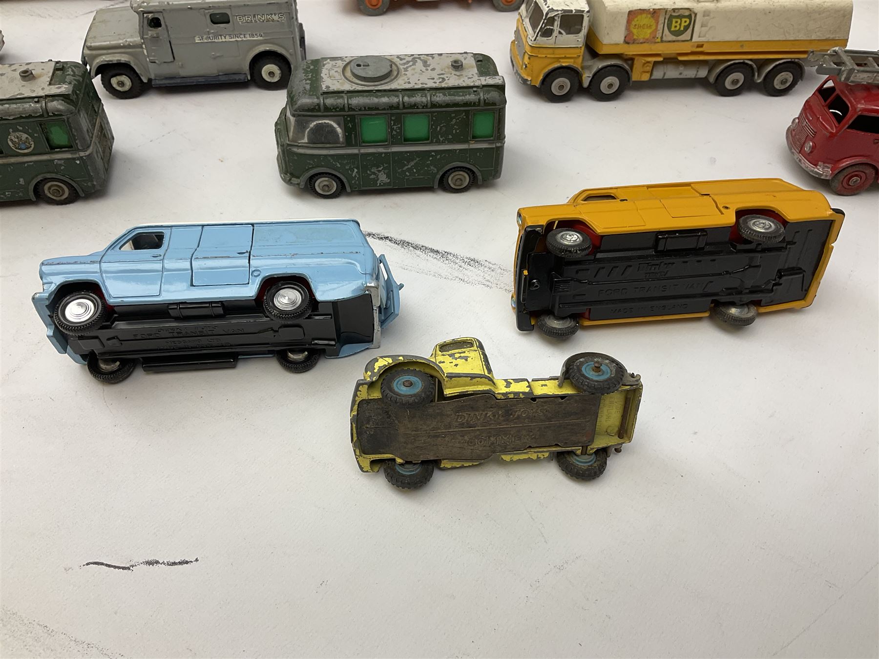 Dinky - thirteen unboxed and playworn die-cast commercial vehicles including two Supertoys 20-Ton Lorry-Mounted Cranes; Leyland Octopus Tanker; Fire Engine No.955; Extending Mast Vehicle No.969; two TV Roving Eye Vans No.968; three Ford Transit Vans; Brinks Armoured Car No.275; etc