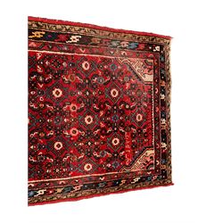 Persian crimson ground runner, the field decorated with Herati motifs,  three-band border, the main band decorated with repeating flowerheads 