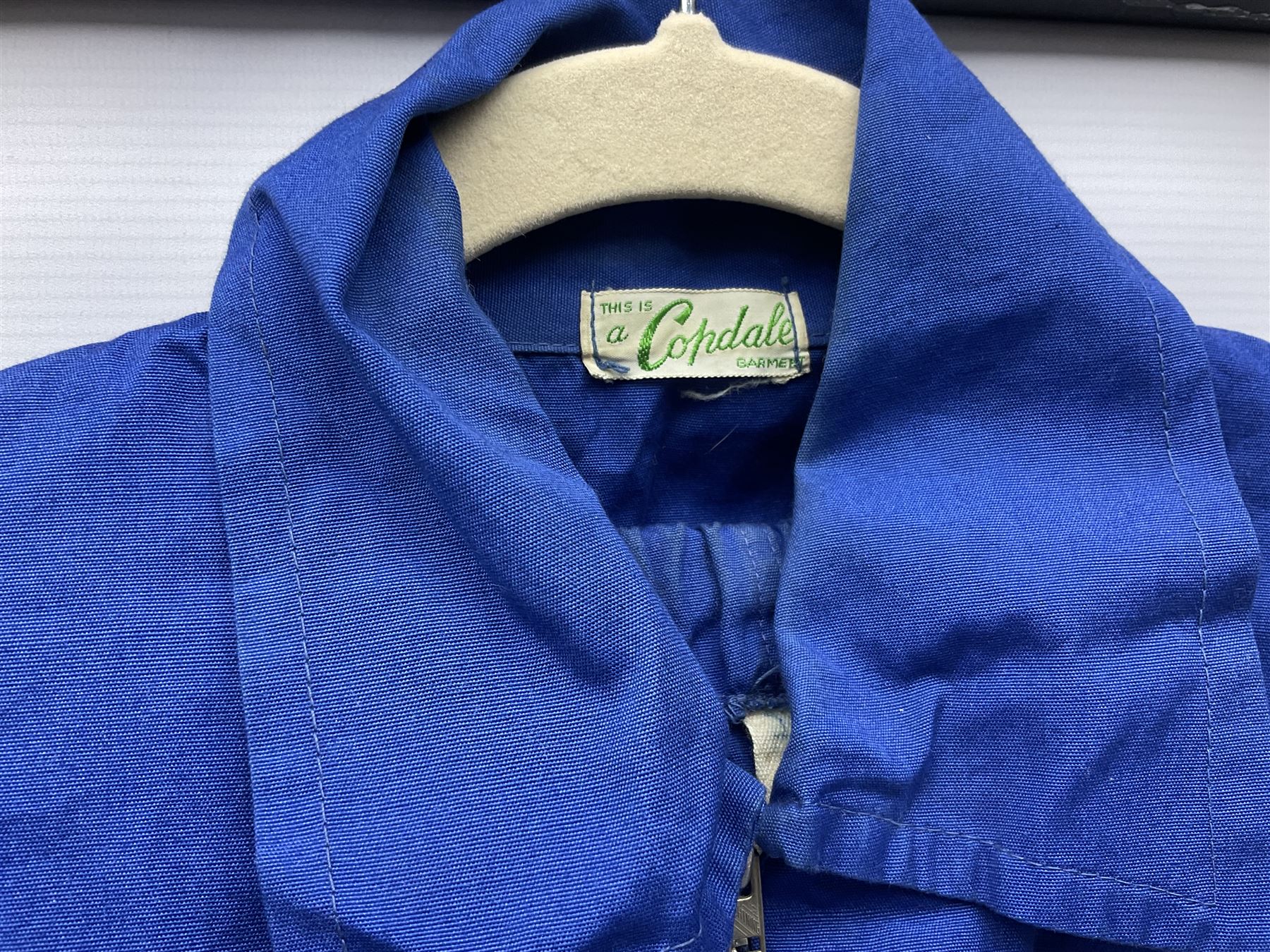 On the direct instructions of Anita Porter nee Lonsbrough Great British Olympic and Commonwealth Games gold medal winning swimmer - collection of early and international memorabilia comprising original Huddersfield Bath Club track suit top bearing eight stitched on cloth badges including British Empire & Commonwealth Games 1958 England Team, YSASA, North Eastern Counties ASA, ESSA Division 3,  English Schools Swimming Association winner etc
The swimming costume Anita wore at the 1958 Commonwealth Games in Cardiff, her first major championships, where she won two gold medals. The grey elastic on the sides, in those days, she would use to make it tighter and more streamlined.
Blue track suit from the 1960 Olympics which she wore on the podium receiving the gold medal.
1960 pool side towelling robe used at the Rome Olympics (interesting to note her name is spelt wrong on the embroidered label).
1962 Commonwealth Games pool side towelling robe used in Perth Australia when winning three Gold medals. 
It was also this year she became BBC Sports Personality of the year, the first female to do so.
Her 'lucky' pool side towel which she took with her to every event she competed in and which can be seen round her neck in many official celebratory photographs. Copies of some of these photographs are included for identification.
In addition there are two souvenir programmes of an evening event to honour Anita at The Theatre Royal Huddersfield and she has kindly signed the front cover on one of these.