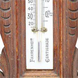 Victorian carved oak aneroid barometer, the foliate crest above a glazed thermometer, with scroll carved sides and circular dial below, H  60cm