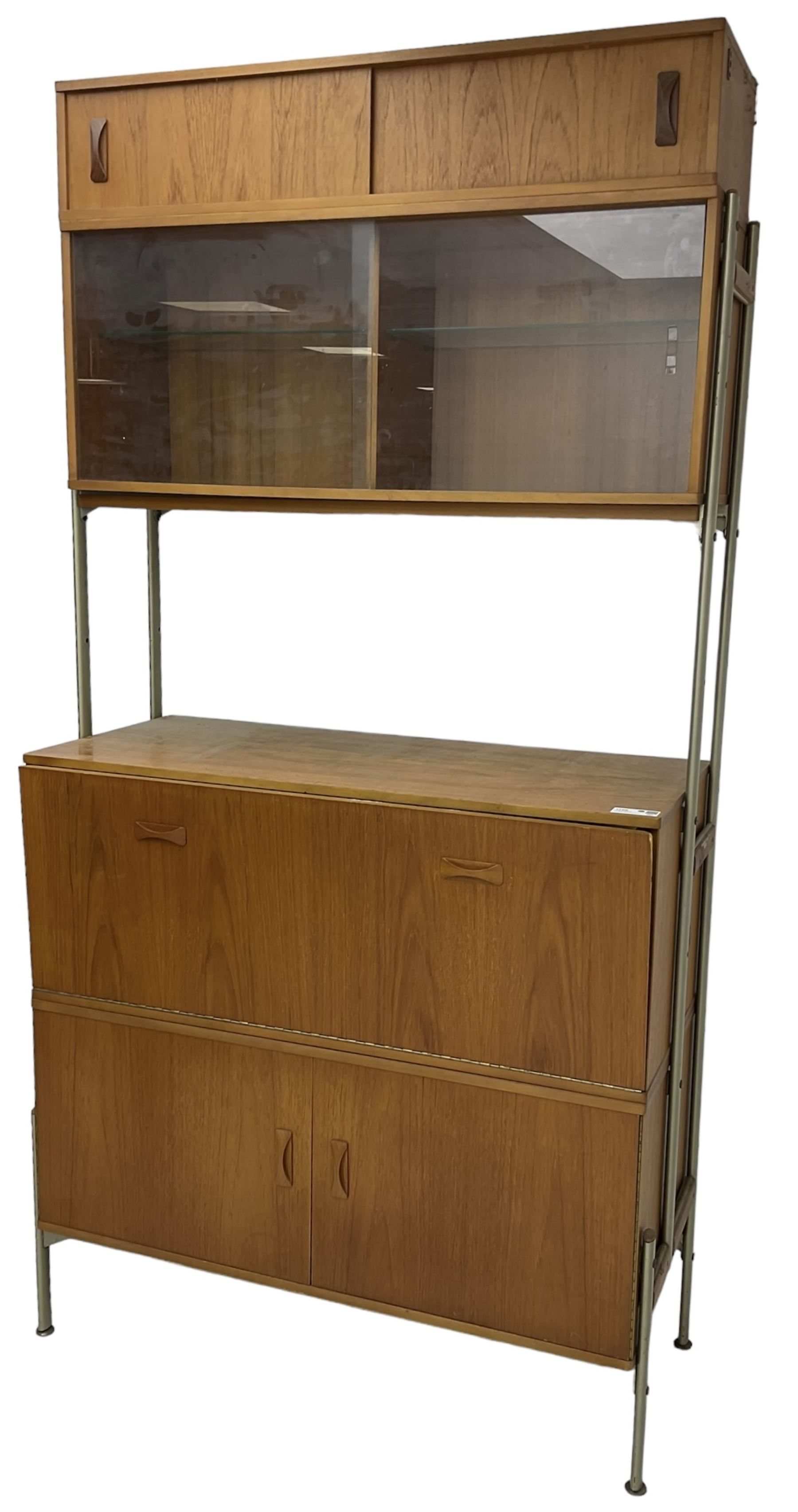 Remploy - mid-20th century teak sectional wall display unit or room divider, raised display cabinet section with sliding glass doors, central fall front section, lower double cupboard section and an additional sliding door section 